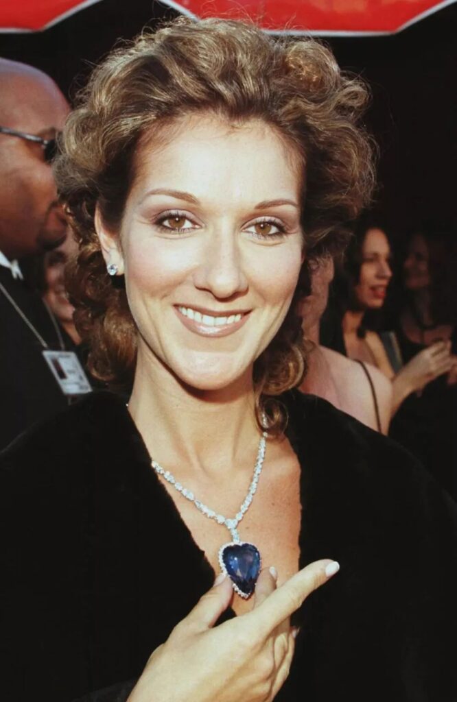 Celine Dion wearing Asprey's Heart of the Ocean necklace, featuring a 171-carat Sri Lankan sapphire and 103 diamonds, valued at $2.2 million.