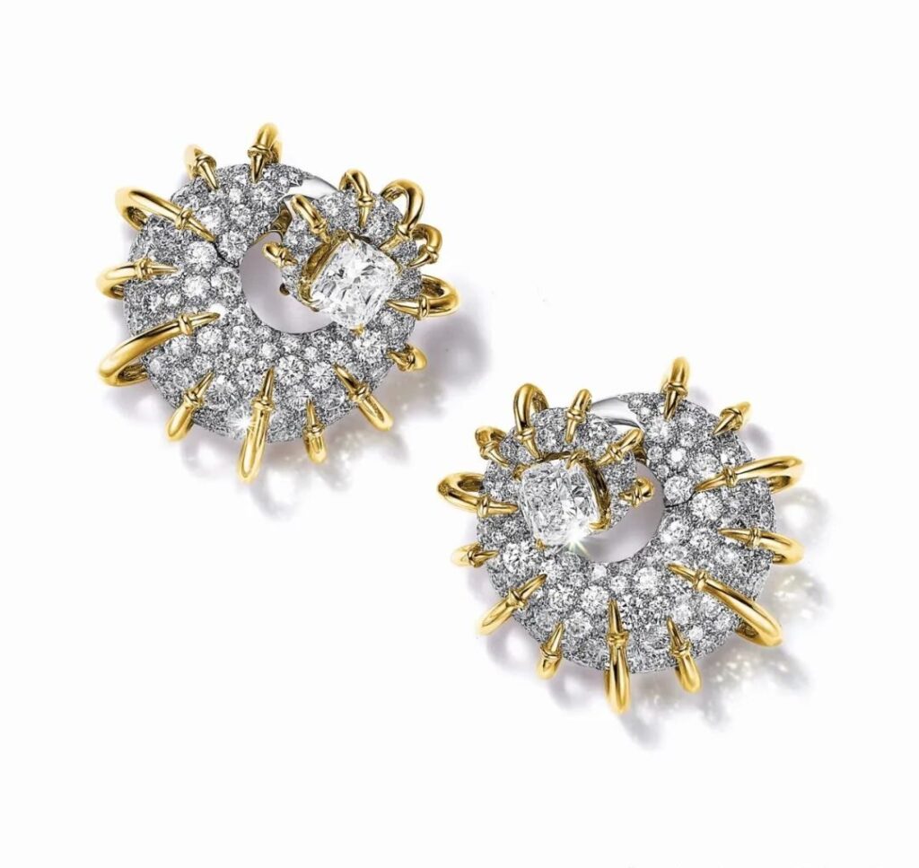 Apollo Gold Earrings, by Tiffany:
Another pair of earrings in the collection, crafted from platinum and yellow gold, features two cushion-cut diamonds totaling over 3 carats, surrounded by round brilliant-cut diamonds.