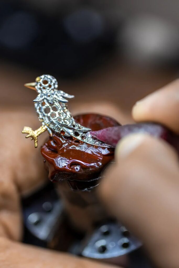 Tiffany craftsman creating the bird shape on the watch dial