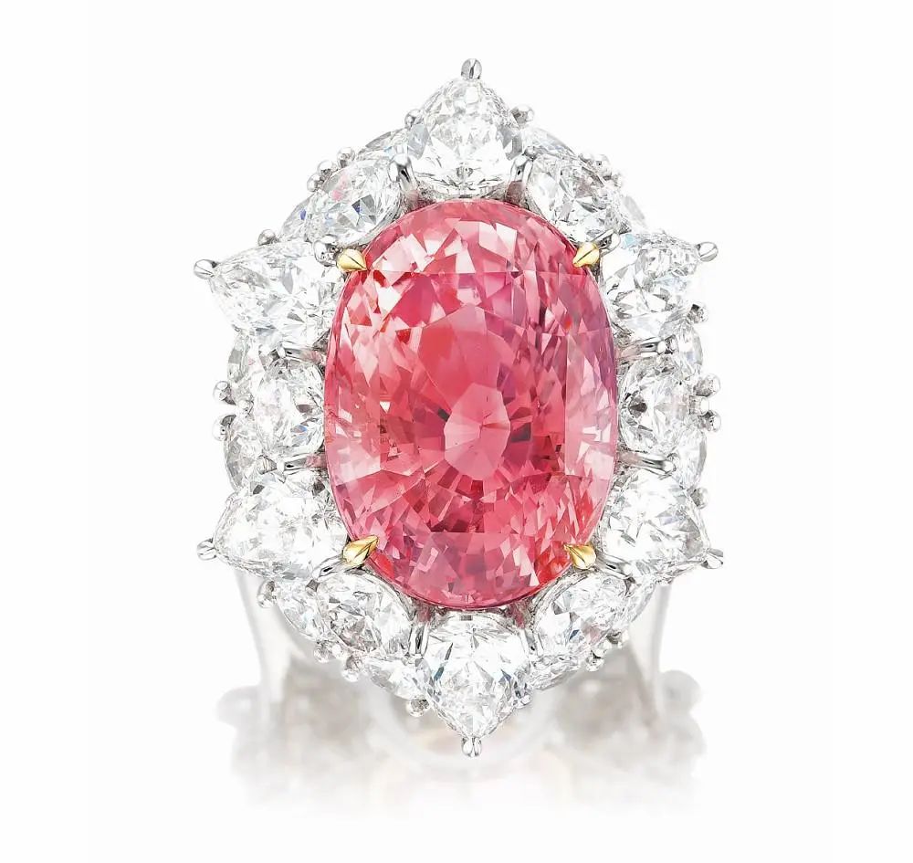 Padparadscha pink sapphire ring
Main stone is a 21.20ct oval-cut Padparadscha pink sapphire
Sourced from Sri Lanka, untreated, surrounded by pear-shaped
and round-cut diamonds totaling 8.00ct, set in platinum and white gold