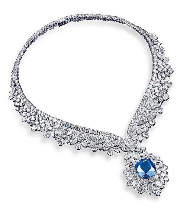 Love in Mist white gold necklace, by Mouawad
Main stone is a cushion-cut sapphire, accented with marquise,
pear, long baguette, and round-cut diamonds