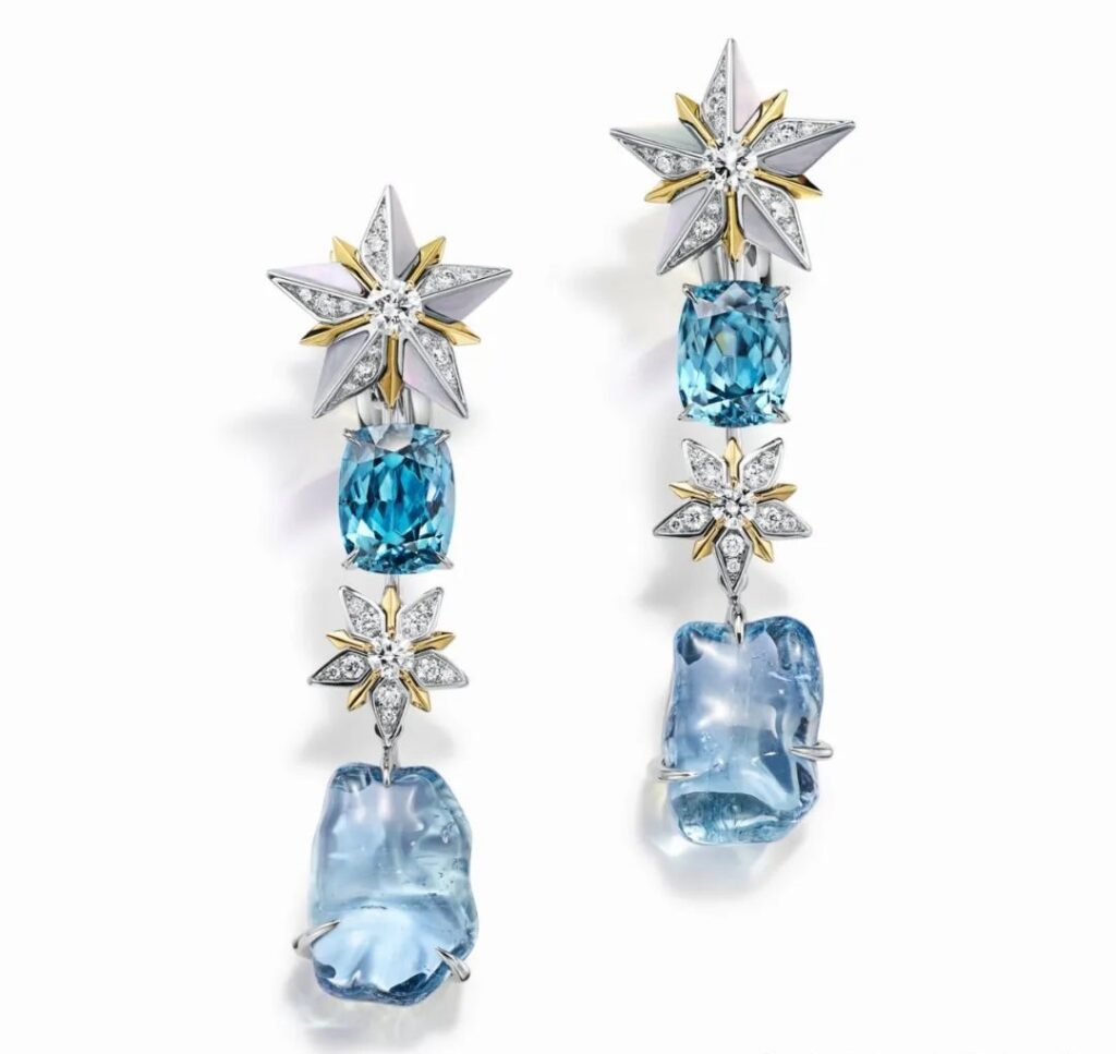 Iconic Star Gold Earrings, by Tiffany:
These earrings, crafted in platinum and yellow gold, are set with blue zircons totaling over 9 carats, blue sapphires exceeding 18 carats, mother-of-pearl, and diamonds.