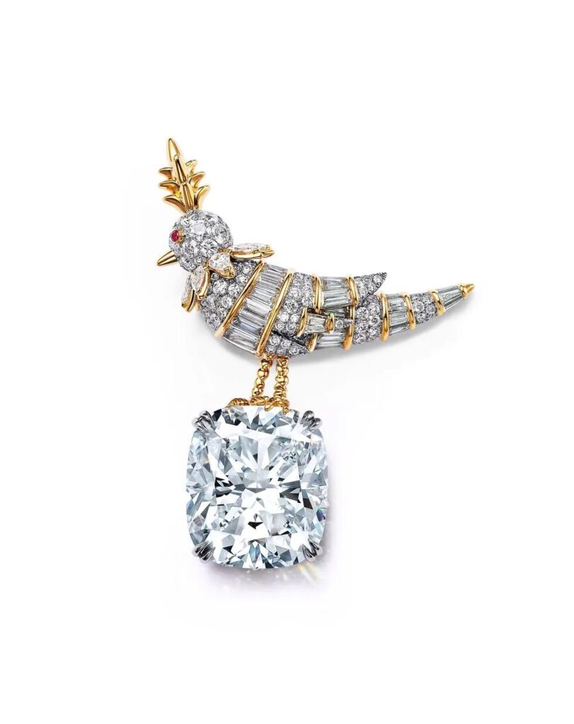 Jean Schlumberger High Jewelry Collection (JEAN SCHLUMBERGER BY TIFFANY) RAINBOW BIRD ON A ROCK brooch: Platinum and 18K yellow gold set with a diamond weighing over 25 carats, rubies, and diamonds.