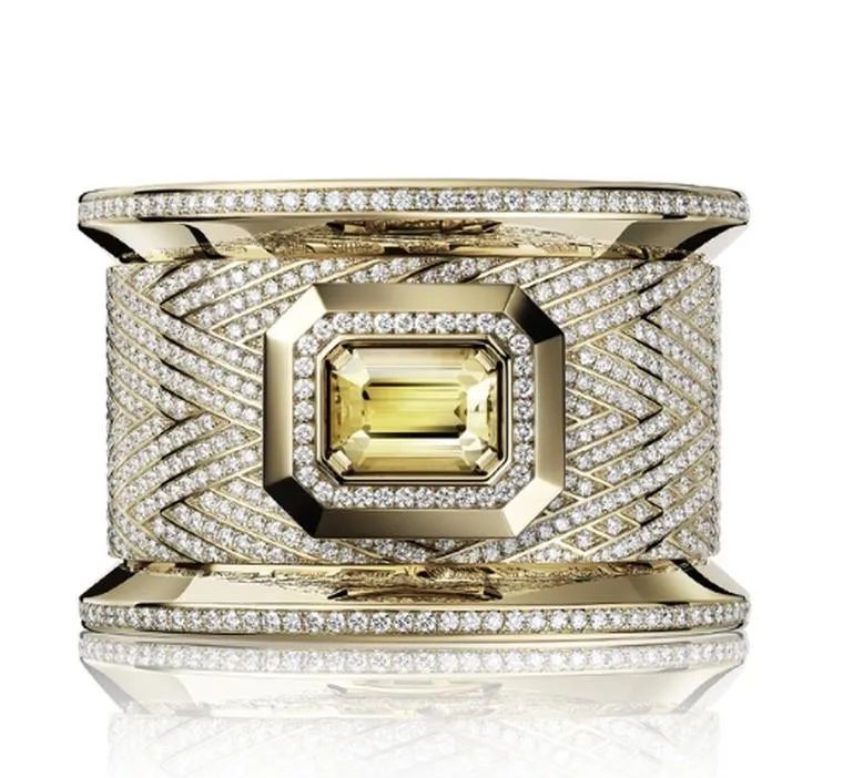 A mini dial is hidden beneath an emerald-cut yellow sapphire (approximately 17.73 carats) in Chanel's one-of-a-kind Bobbin Cuff Couture.