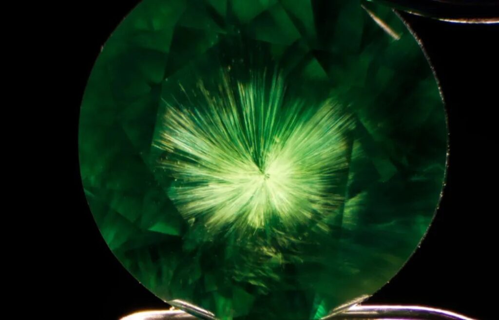 "Horsetail" inclusions in Russian demantoid garnet