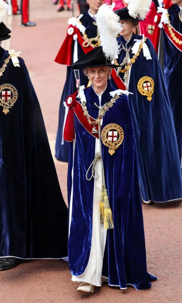 Duchess of Gloucester being invested in the Order of the Garter, wearing the ceremonial robes.