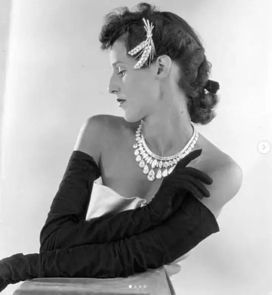 Babe Paley wearing a Van Cleef & Arpels brooch as a hair accessory, paired with an elaborate necklace