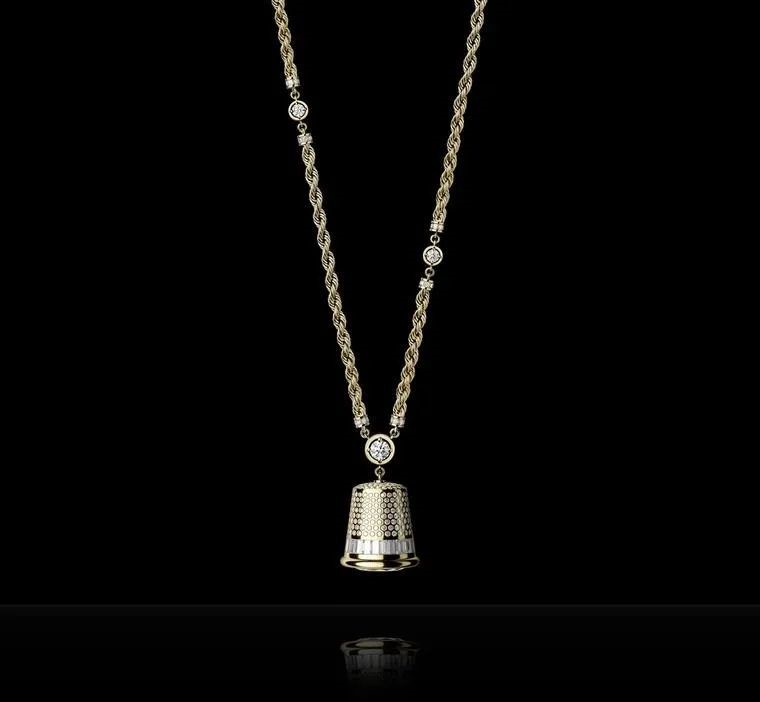 This substantial tubular case, suspended from a long gold chain, is set with diamonds and features a dial at its base. It is limited to 20 pieces.