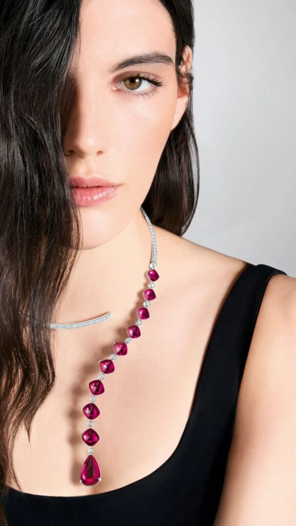 Goutte Question Mark Necklace: Crafted in white gold, set with 9 sugar-loaf cut rubellites and 1 pear-shaped rubellite (total weight 41.54 carats) and crystal, pavé-set with diamonds; this necklace embodies Boucheron's concept of versatile jewelry, offering multiple ways to wear.