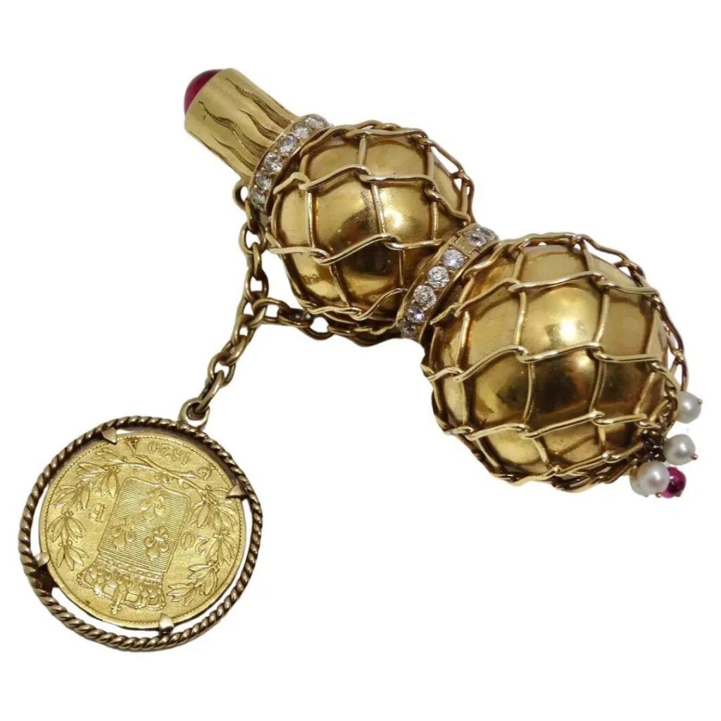 Cartier perfume pendant, circa 1940
Gold, pearls, diamonds, tourmaline
And a 1920 French Louis XIII gold coin