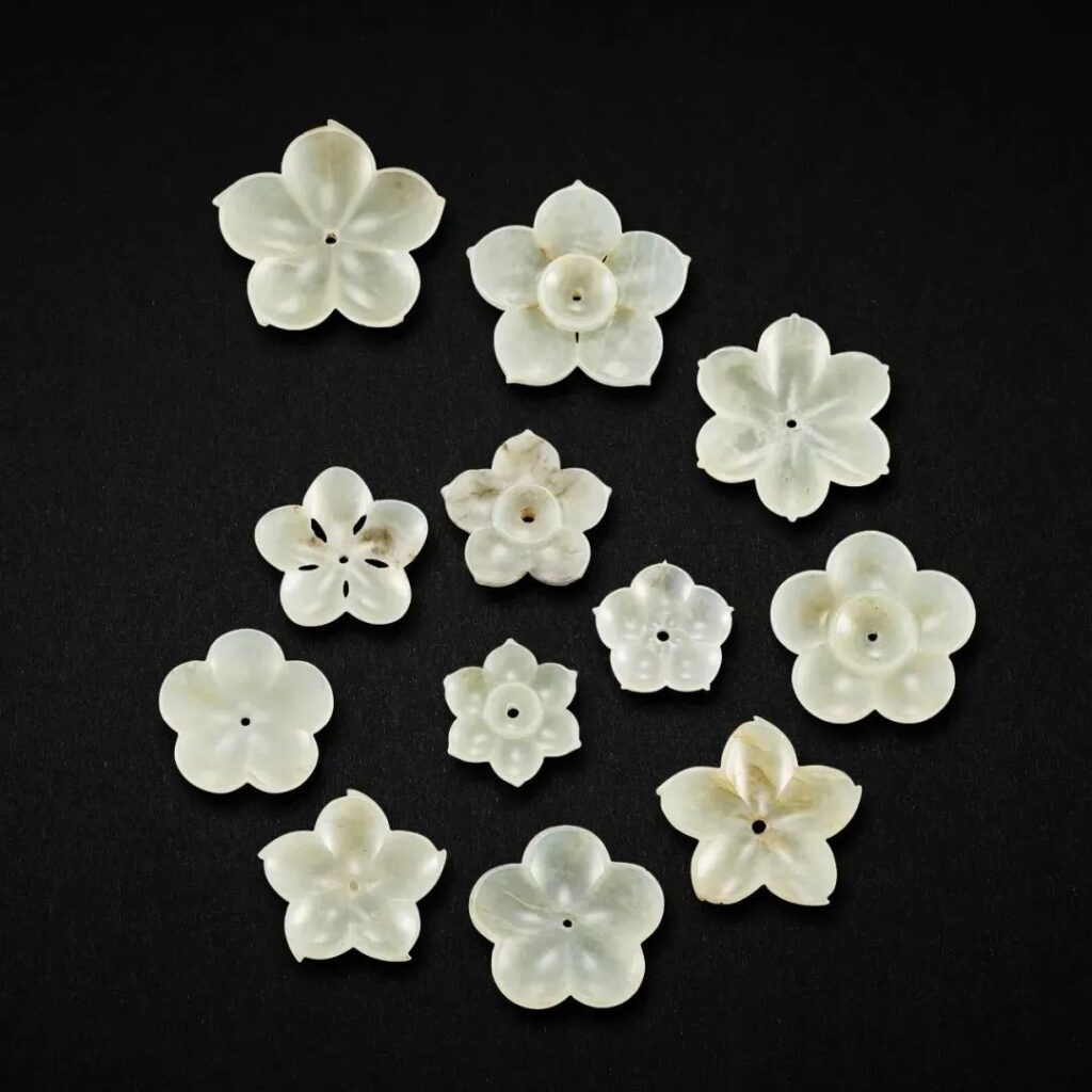 Jin to Ming Dynasty set of twelve green and white jade floral ornaments