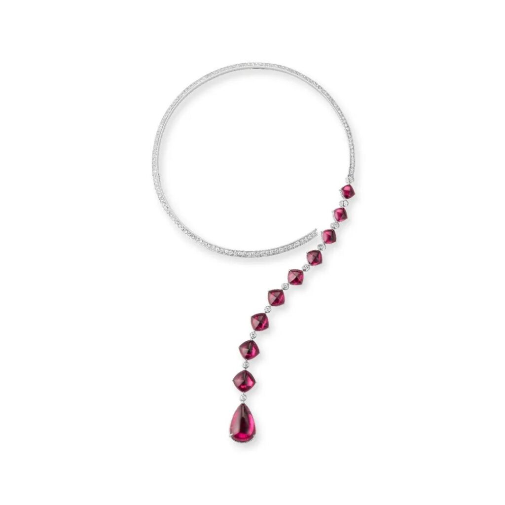 Goutte Question Mark Necklace: Crafted in white gold, set with 9 sugar-loaf cut rubellites and 1 pear-shaped rubellite (total weight 41.54 carats) and crystal, pavé-set with diamonds; this necklace embodies Boucheron's concept of versatile jewelry, offering multiple ways to wear.