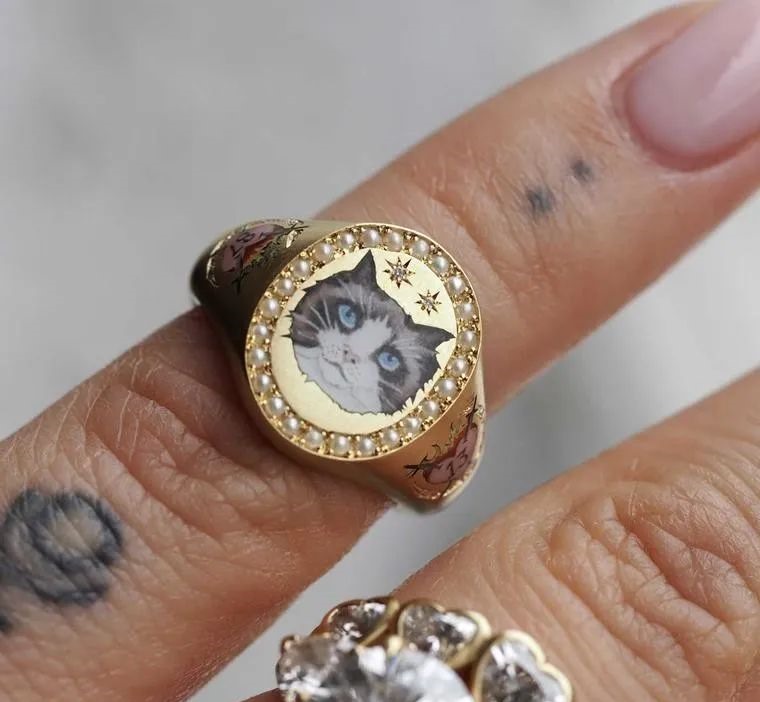 Like all of Cece's jewelry, Taylor Swift's custom ring is handcrafted in London using traditional techniques such as champlevé enameling, hand-set gemstones, and engraving forms inspired by Victorian jewelry.