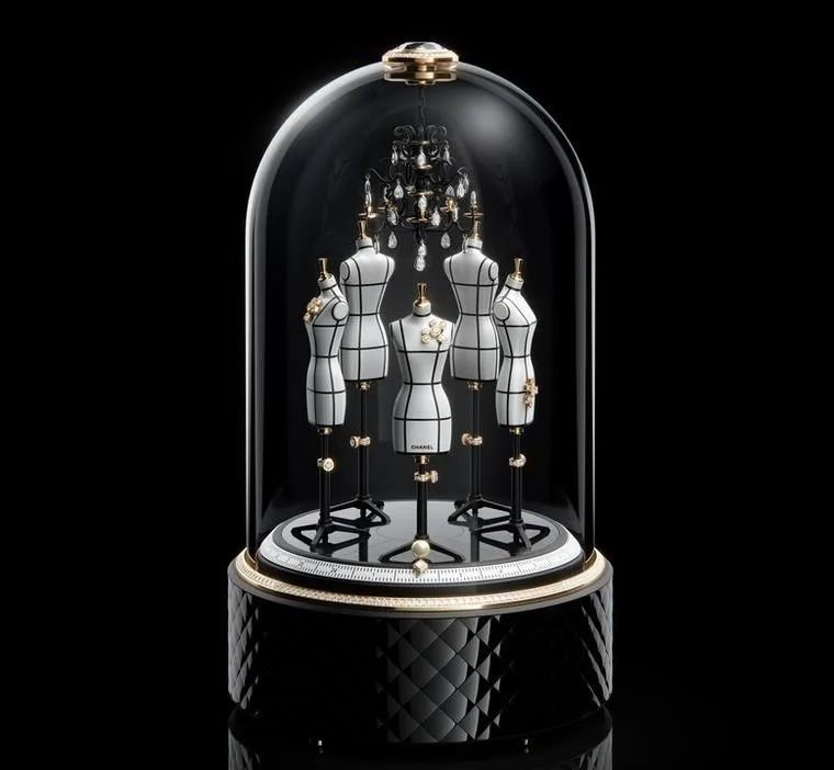 This unique clock features five bejeweled mannequins dancing under a chandelier and can also function as a music box playing "My Woman," a song favored by Mademoiselle Chanel.