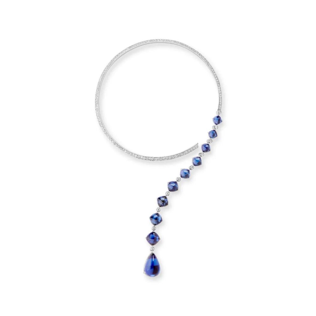 Goutte Question Mark Necklace: Crafted in white gold, set with 9 sugar-loaf cut tanzanites and 1 pear-shaped tanzanite (total weight 56.46 carats) and crystal, pavé-set with diamonds.