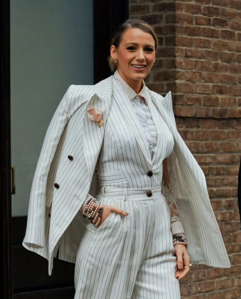 Blake Lively in a suit with an orchid brooch