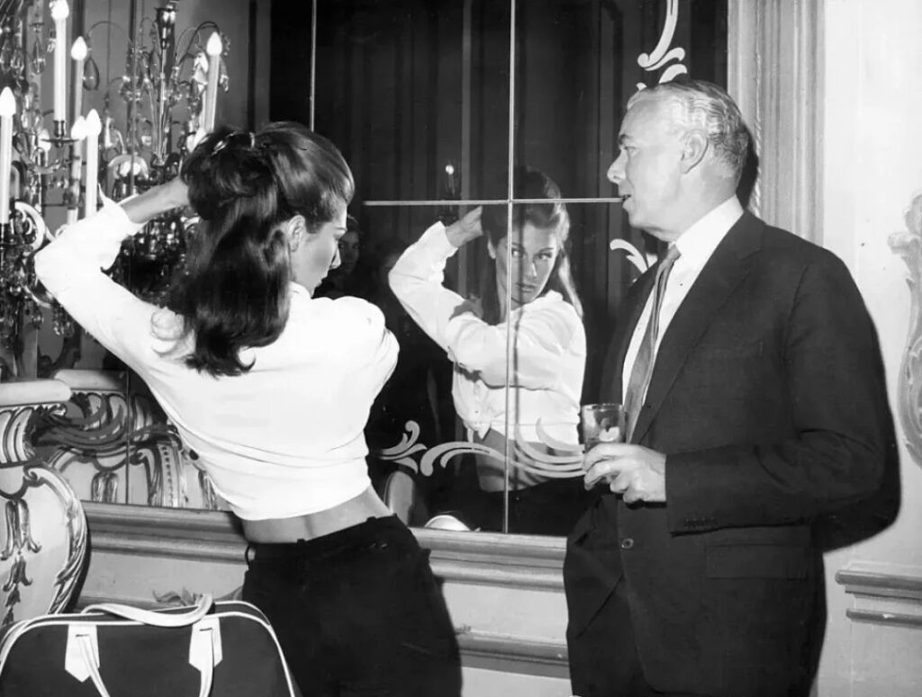 Fiona Thyssen (former fashion model Fiona Campbell Walter) posing in front of a mirror at a charity fashion show at a newly opened department store in Manhattan, New York, 1965.