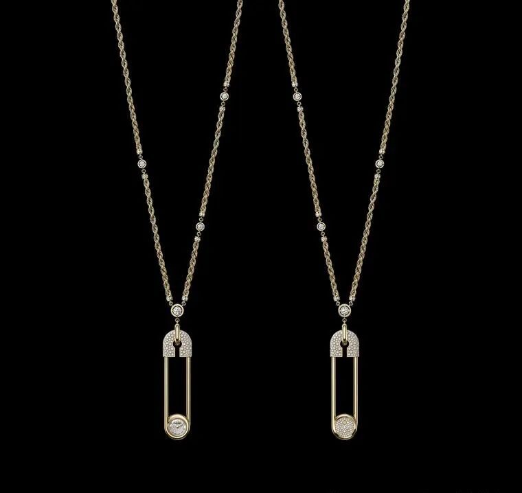 A glittering long necklace adorned with golden safety pins, featuring miniature diamond-set dials, limited to 20 pieces.