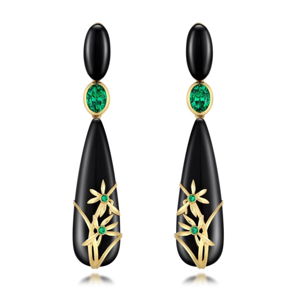 The "Golden Orchids" yellow gold earrings by MidnightOperaHouse X Gemfields are set with black onyx and round and oval-cut emeralds, certified to be from Zambia.