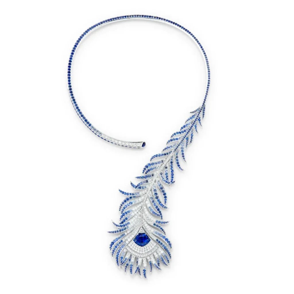 Plume de Paon Question Mark Necklace: Crafted in white gold, set with a 6.34-carat oval-cut Ceylon sapphire, adorned with diamonds and sapphires.