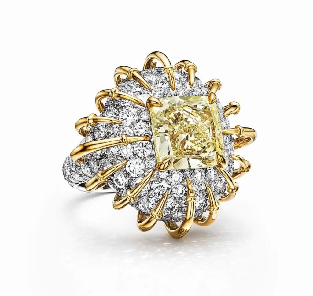 Apollo Gold Ring, by Tiffany:
Crafted in platinum and yellow gold, this ring showcases a central fancy vivid yellow diamond of over 6 carats, surrounded by additional yellow diamonds and colorless diamonds.