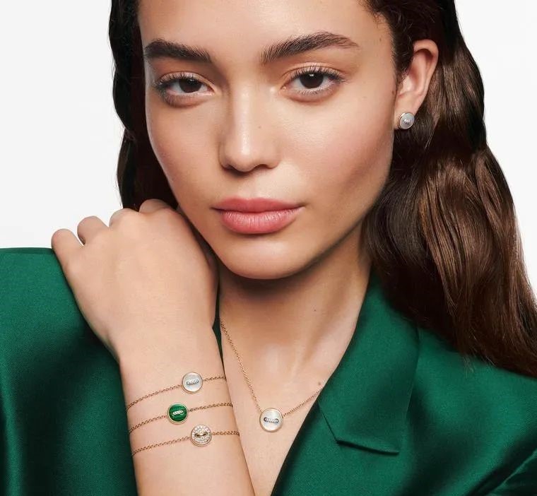 A set of necklace, bracelet, and earrings from Pomellato's Pom Pom Dot collection, featuring malachite, mother-of-pearl, and diamonds.