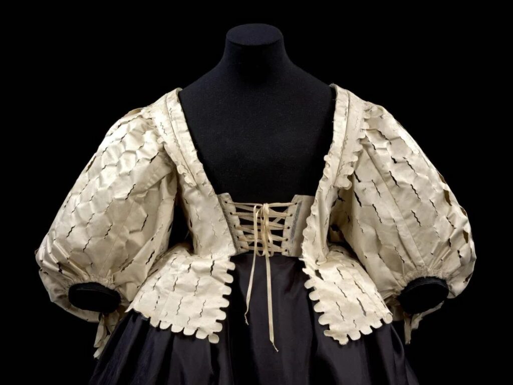 An early 17th-century English-made bodice in the V&A Museum clearly shows the front lacing section, which the triangular stomacher was designed to cover.