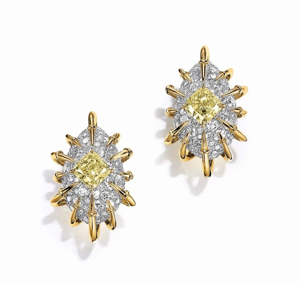 Apollo Gold Earrings, by Tiffany:
These earrings, made of platinum and yellow gold, feature two fancy vivid yellow diamonds with a combined weight of over 3 carats, accented with additional diamonds.