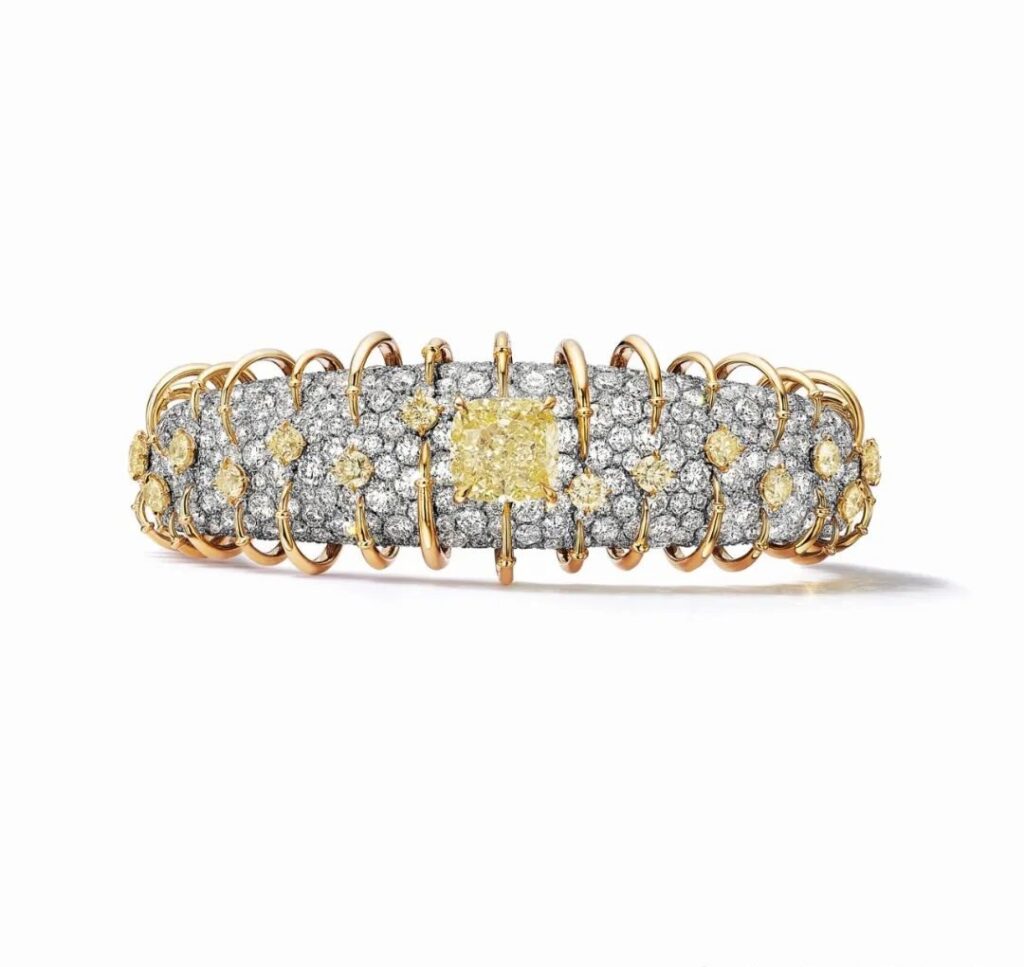 Apollo Gold Bracelet, by Tiffany:
This bracelet is created using platinum and yellow gold, with a central fancy vivid yellow diamond of over 5 carats, complemented by yellow and colorless diamonds.