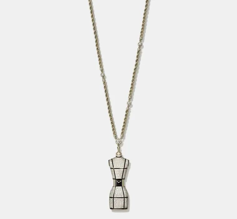 Chanel's Bust Long necklace showcases a diamond-encrusted miniature tailor's mannequin suspended on a gold chain, which slides open at the waist to reveal a hidden watch dial. Limited to twenty pieces.