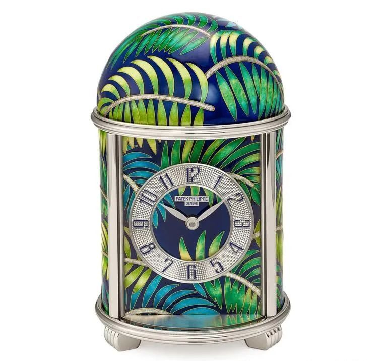 The face of this dome clock is arched with palm leaves and is limited to five pieces. Cloisonné enamel and white enamel are used to create this captivating scene.