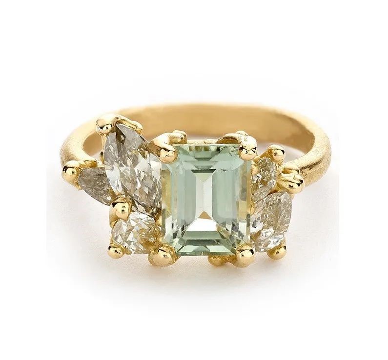 Luminous cluster gold ring, by Ruth Tomlinson.
The main stone is a 2.2ct emerald-cut green tourmaline, accented with diamonds.