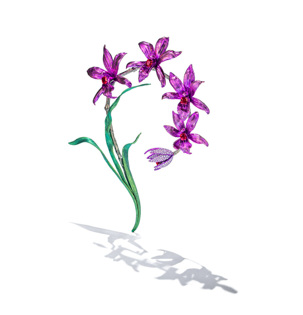 The ANNA HU Orchid Brooch incorporates the classic "question mark necklace" design